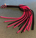 Pink and black beaded flogger