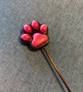 Pink and black paw