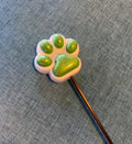 White and green paw
